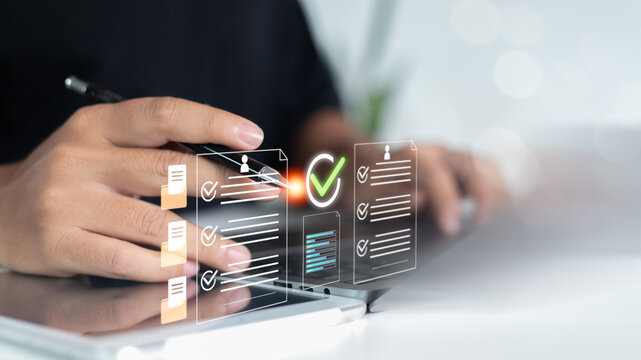 Hand reviewing resumes and documents on a virtual interface with a checklist and approval icon, HR digital recruitment, resume screening system, and applicant evaluation in the business process.