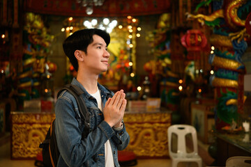 Tourist Paying Respect Inside a Chinese Temple, Cultural Travel Experience Concept