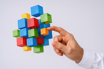 Close-up of a hand touching colorful 3D cubes representing technology innovation.