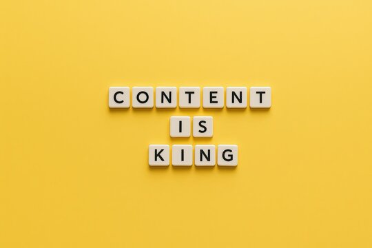 Naklejki Motivational quote content is king made with letter cubes arranged on yellow background.