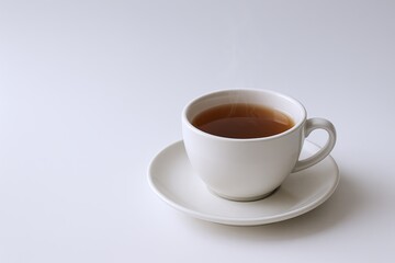 Obraz premium Simple White Ceramic Cup Filled with Hot Coffee on White Saucer Isolated.