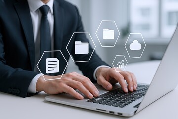 Business professional using laptop with digital cloud storage and data analysis icons.