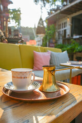 Turkish Coffee in White Ceramic Cup and Copper Cezve, Outdoor Café in Montenegro