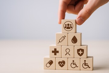 Hand arranging wooden blocks with health and medical symbols on a white background.