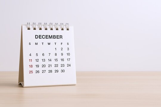 Desktop December Calendar on Wooden Surface with Clear White Background.
