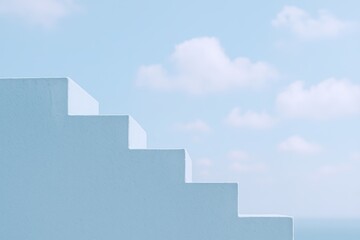Fototapeta premium Modern white staircase with steps leading to sky and clouds in bright outdoor setting.