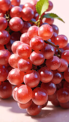 Fresh red grapes glisten with droplets of water, clustered tightly together on their stems
