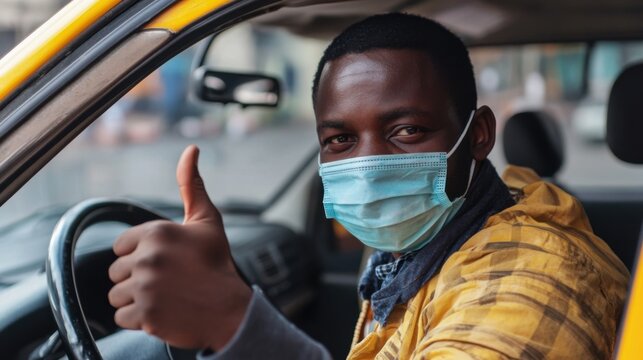 African American taxi driver wearing a protective face mask giving thumbs up - Powered by Adobe