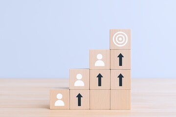 Wooden Blocks with Arrow and User Icons Stacked in Growing Hierarchy on Light Background.