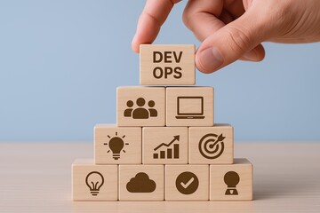 Hand stacking wooden blocks with icons representing teamwork progress and innovation.