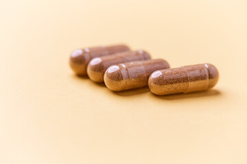 Carnitine capsules. Concept for a healthy dietary supplementation. Bright paper background. Soft focus. Close up.	
