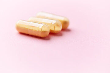 Coenzyme Q10 capsules. Antioxidants. Concept for a healthy dietary supplementation. Bright paper background. Soft focus. Close up. Copy space.	