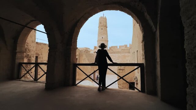 Woman Silhouetted in Historic Monastir Ribat in Monastir, Tunisia with Tower in Background