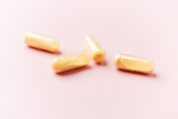 Coenzyme Q10 capsules. Antioxidants. Concept for a healthy dietary supplementation. Bright paper background. Soft focus. Close up. Copy space.	