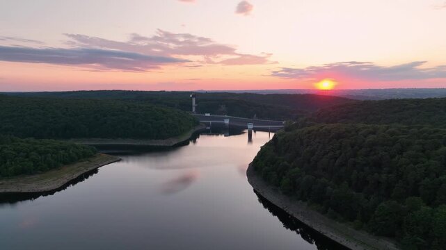 Aerial footage over lake Gileppe and the concrete dam in Wallonia, Belgium at sunset