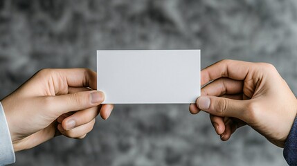 Blank business card held by two hands over dark textured background ideal for branding or identity mockup.