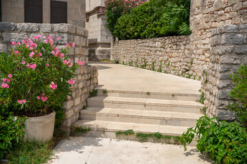 Stone stairs and flowering oleander in the old town of Osor, Croatia