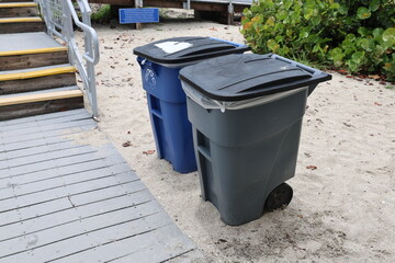 garbage bin on white sand beach