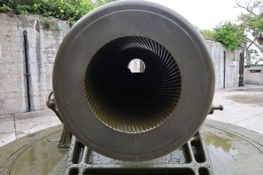 Close-up photo showing rifling grooves inside the barrel of a cannon, highlighting the spiral cuts used for projectile stabilization