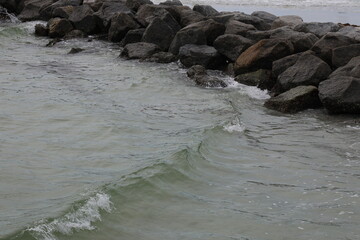 rocks brake waves in the water