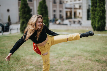 A cheerful young woman extends her leg in an energetic dance movement outdoors among trees.