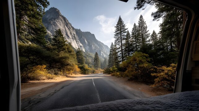 Open road view from inside a camper van in a scenic mountain landscape