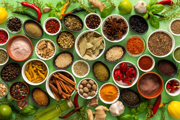 A colorful assortment of fresh, fragrant spices and herbs displayed on a soft green background, capturing a vibrant culinary essence