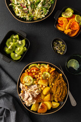 Enjoy a nutritious breakfast with baked sweet potato, carrots, zucchini, chicken breast, and lentil cutlets, complemented by a fresh salad and kiwi for dessert