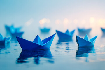 Obraz premium Paper boats floating on calm water at sunrise