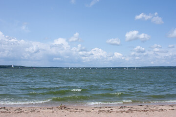 Sailing yacht race. Yachting. Sailing. Yachts on the water against a blue cloudy sky. Water with waves