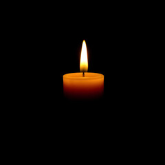 Burning candle on a black background