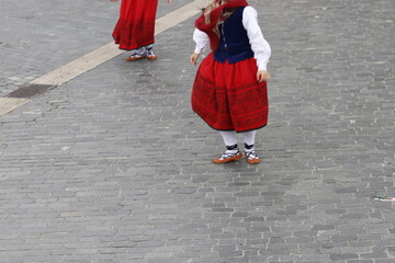 Young women dancing wearing the traditional basque dress