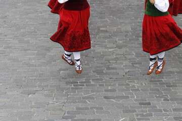 Young women dancing wearing the traditional basque dress