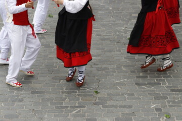 Young women dancing wearing the traditional basque dress