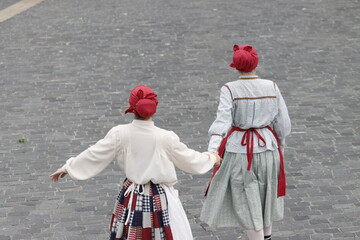 Young women dancing wearing the traditional basque dress
