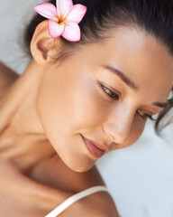 Beautiful Woman With Plumeria Flower Enjoying Spa Vacation Moment