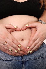 A man hugs his pregnant wife's belly. Concept of pregnancy and family.