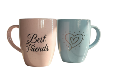 Two mugs one pink with best friends and one blue with a heart PNG  close up view