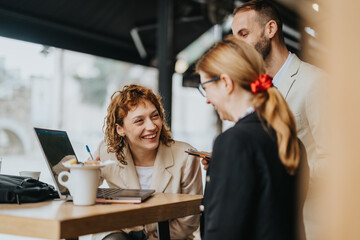 Smiling business entrepreneurs discussing ideas outdoors with a laptop. The informal setting creates a relaxed and productive atmosphere, promoting collaboration and teamwork among colleagues.