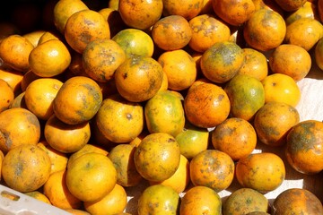 A close-up background photo of a bunch of fresh sweet oranges. These sweet and tangy oranges are rich in vitamin C. The photo fits themes of health, food, and beverage
