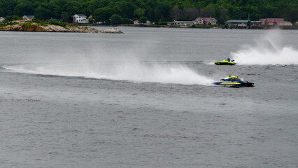 Fototapeta premium Two hydroplane racing boats going in opposite directions during a race