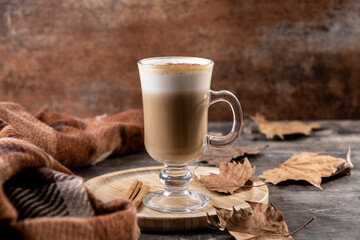 Maple Latte with Cinnamon in Glass Mug on wooden table
