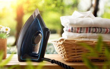 Eco-friendly ironing concept with iron and shirts in nature