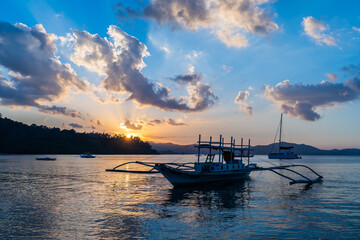 Sunrise Return Of Fishing And Crab Boats Under Blue Sky And Clouds Photo
