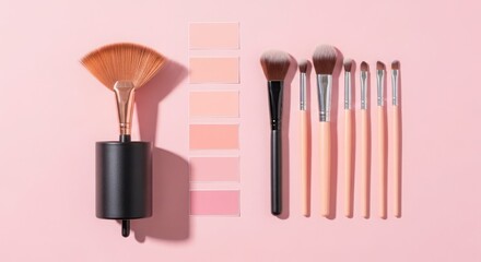 A collection of makeup brushes and swatches of various shades of pink and peach