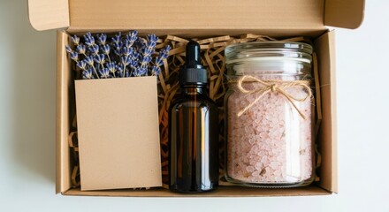 A beautifully curated gift box containing lavender amber dropper bottle and pink bath salts
