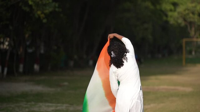 Indian woman waving national tricolor flag