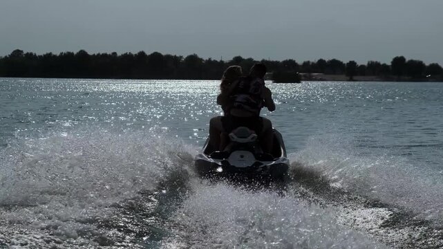 Happy couple riding a jet ski. Concept joy, freedom, and shared adventure.