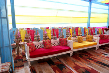 Colorful Seating Arrangement for Haldi Ceremony with Draped Chairs and Traditional Sofas