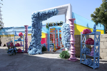 Vibrant Haldi Ceremony Venue with Pastel Floral Decor and Colorful Drapes 